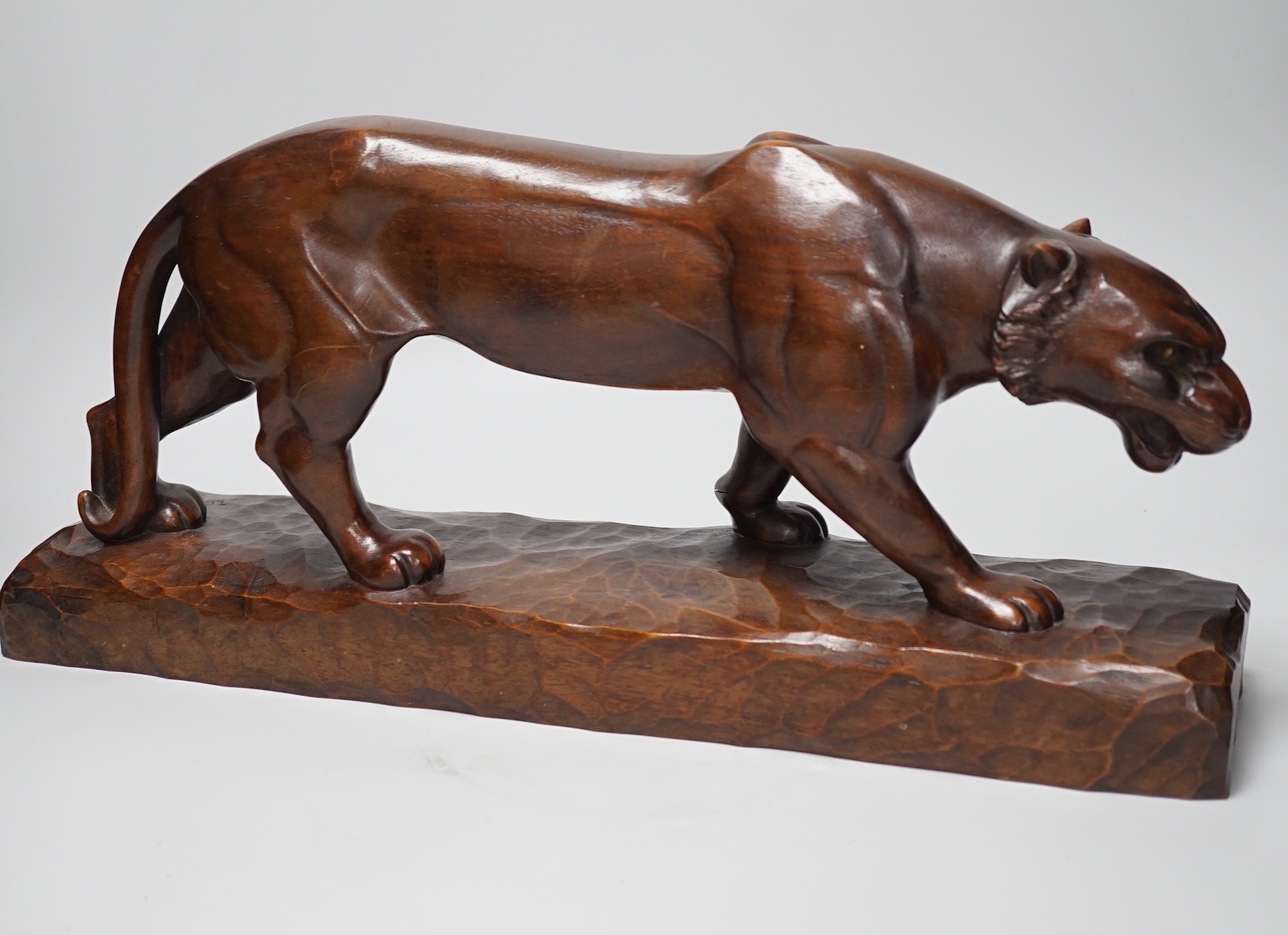 A French carved walnut model of a tiger, signed Chartron, 47cms wide